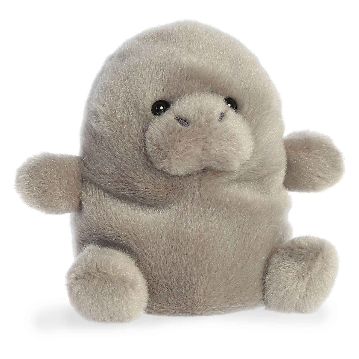 Angled view of the Aurora Palm Pals 5-inch Blubs Manatee plush sitting upright, showing its soft grey fur, rounded snout, and small flippers.