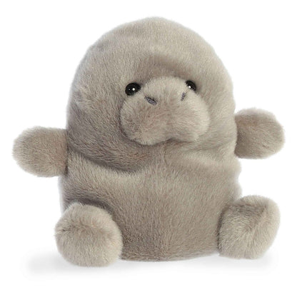 Angled view of the Aurora Palm Pals 5-inch Blubs Manatee plush sitting upright, showing its soft grey fur, rounded snout, and small flippers.