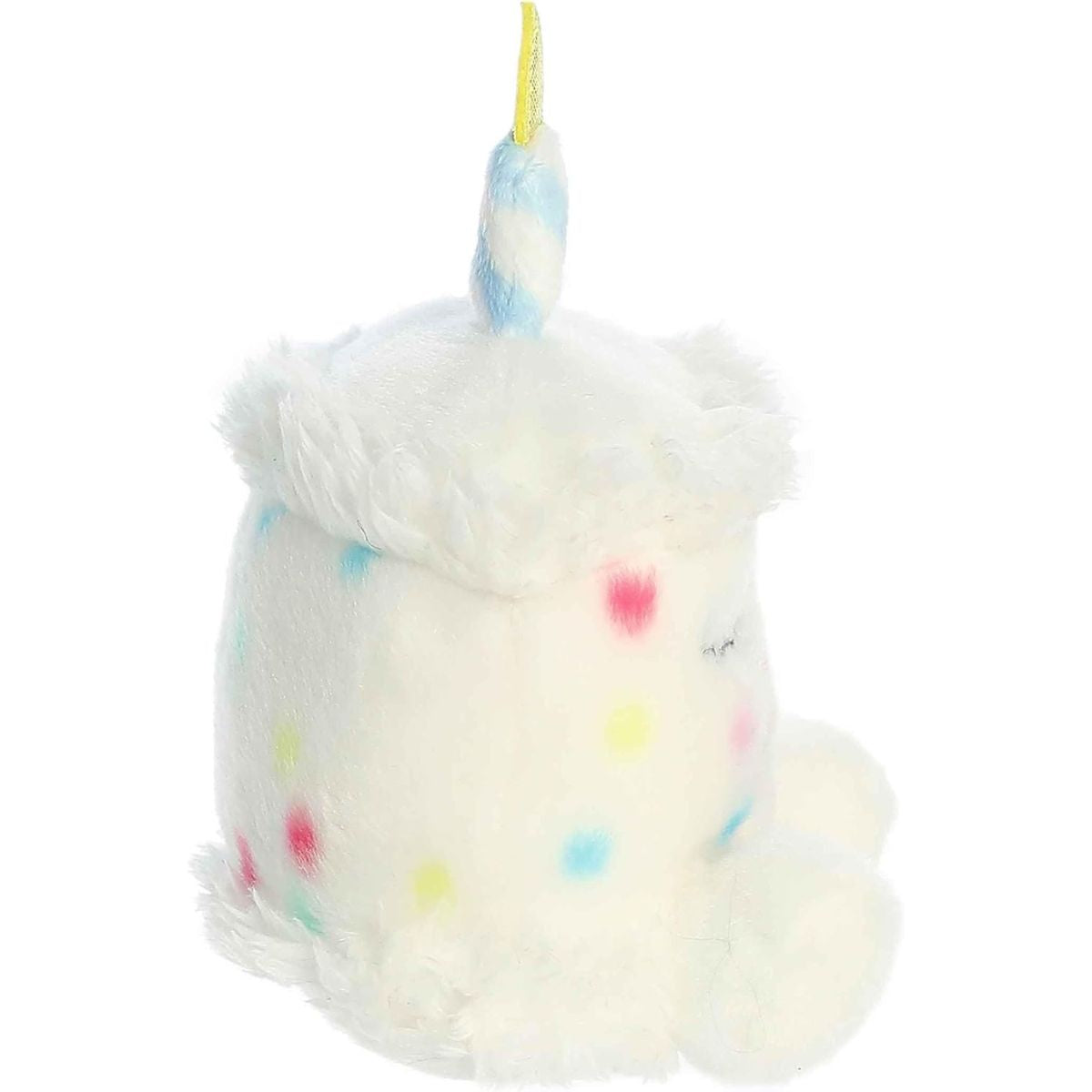 Side profile view of the Aurora Palm Pals cake plush highlighting its fluffy frosting brim and striped candle.
