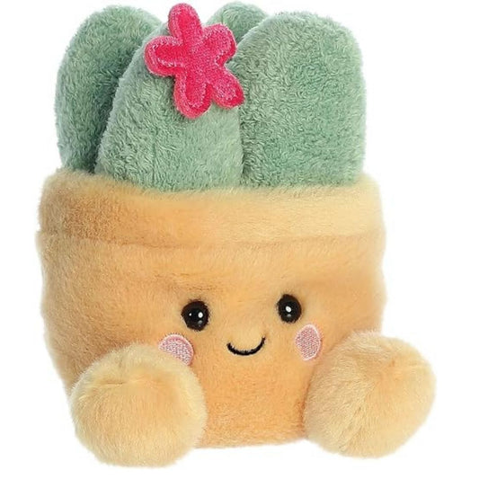 Aurora 5-inch Palm Pals Seyla Succulent plush toy showing its light tan pot body with a smiling face, blushing cheeks, sage green succulent leaves, and a tiny pink flower on top.