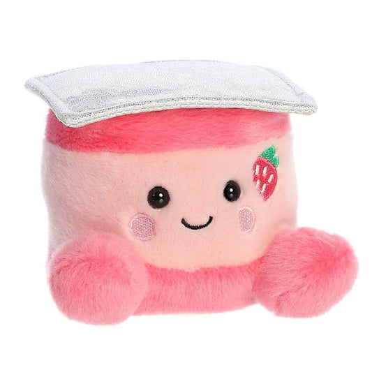 Aurora 5-inch Palm Pals Yona Strawberry Yogurt plush toy showing its light pink cup body, hot pink rim and feet, white overlapping fabric lid, and an embroidered strawberry on its cheek.