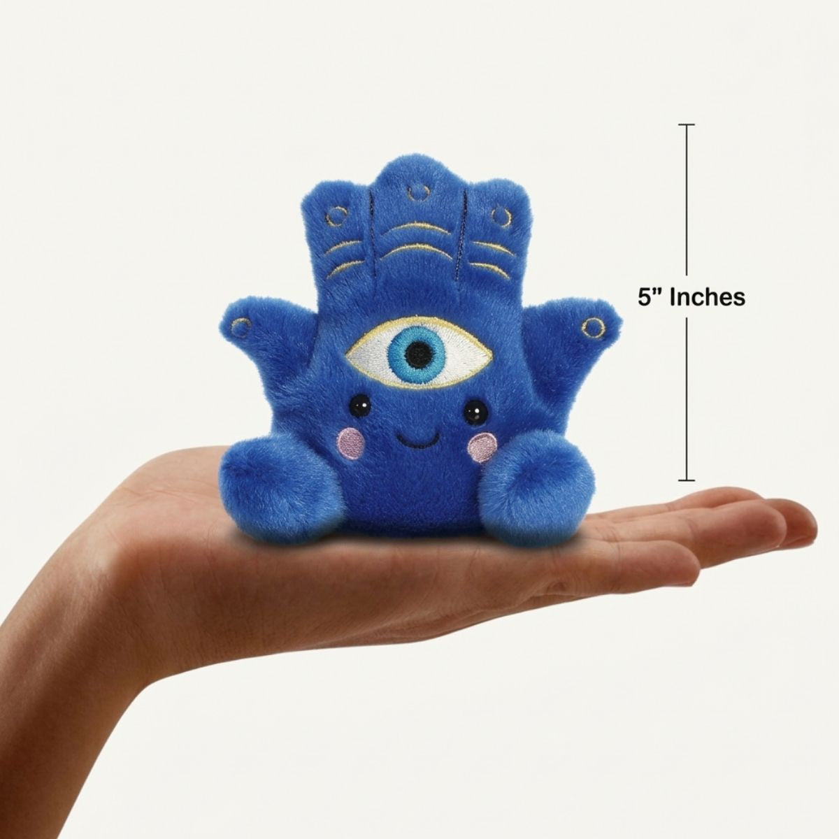 The miniature Farah Hamsa plush sitting balanced in an open human hand under a 5-inch height graphic indicator.