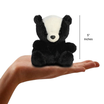 The miniature Scout Skunk plush sitting balanced in an open human hand under a 5-inch height graphic indicator.
