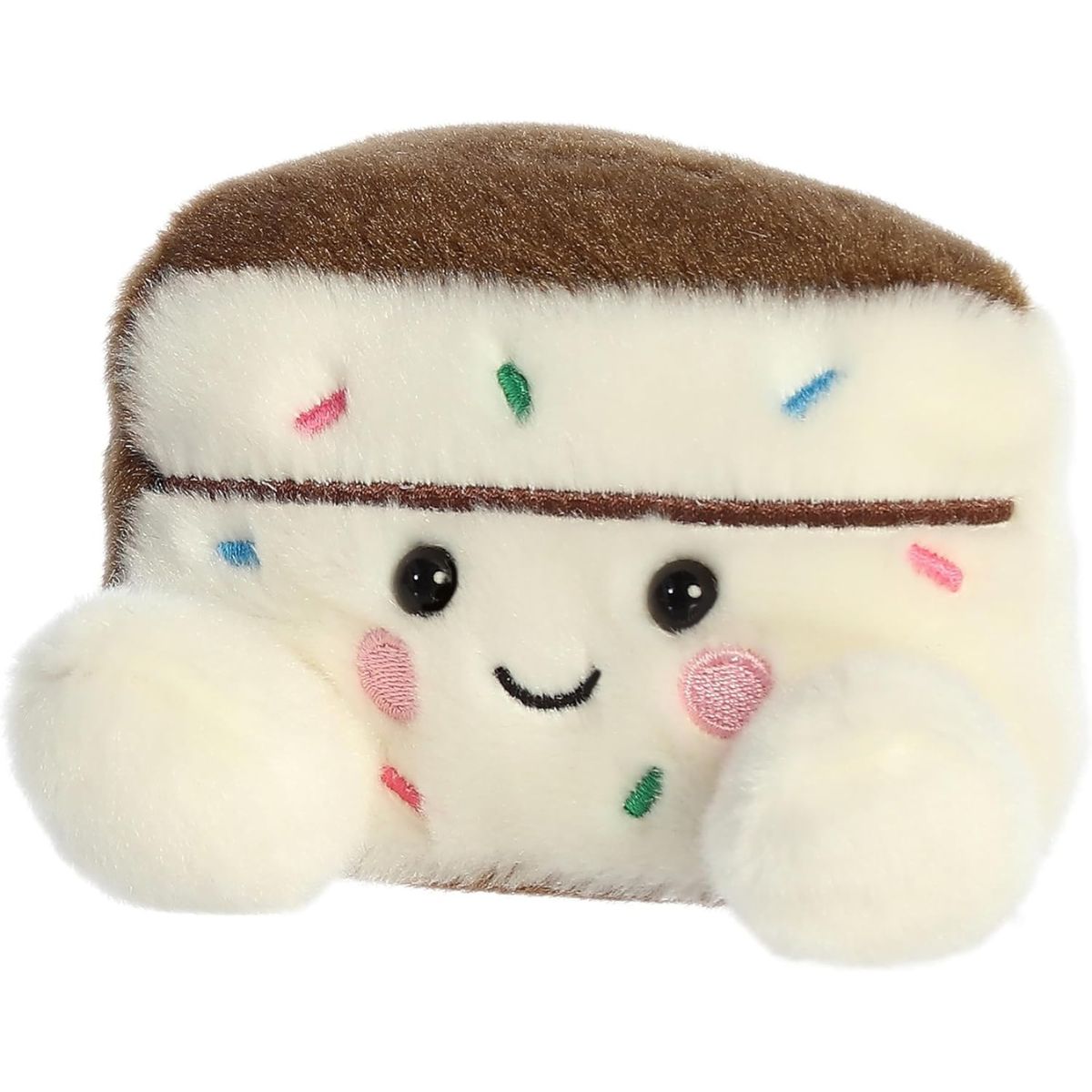 Slightly angled front right view of the smiling Palm Pals Sprinkles Cake Slice plush with pink cheeks.