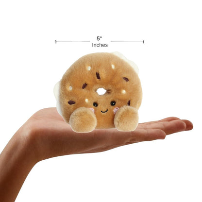 The miniature Tony Everything Bagel plush sitting inside an open human hand displaying a 5-inch width indicator graphic.