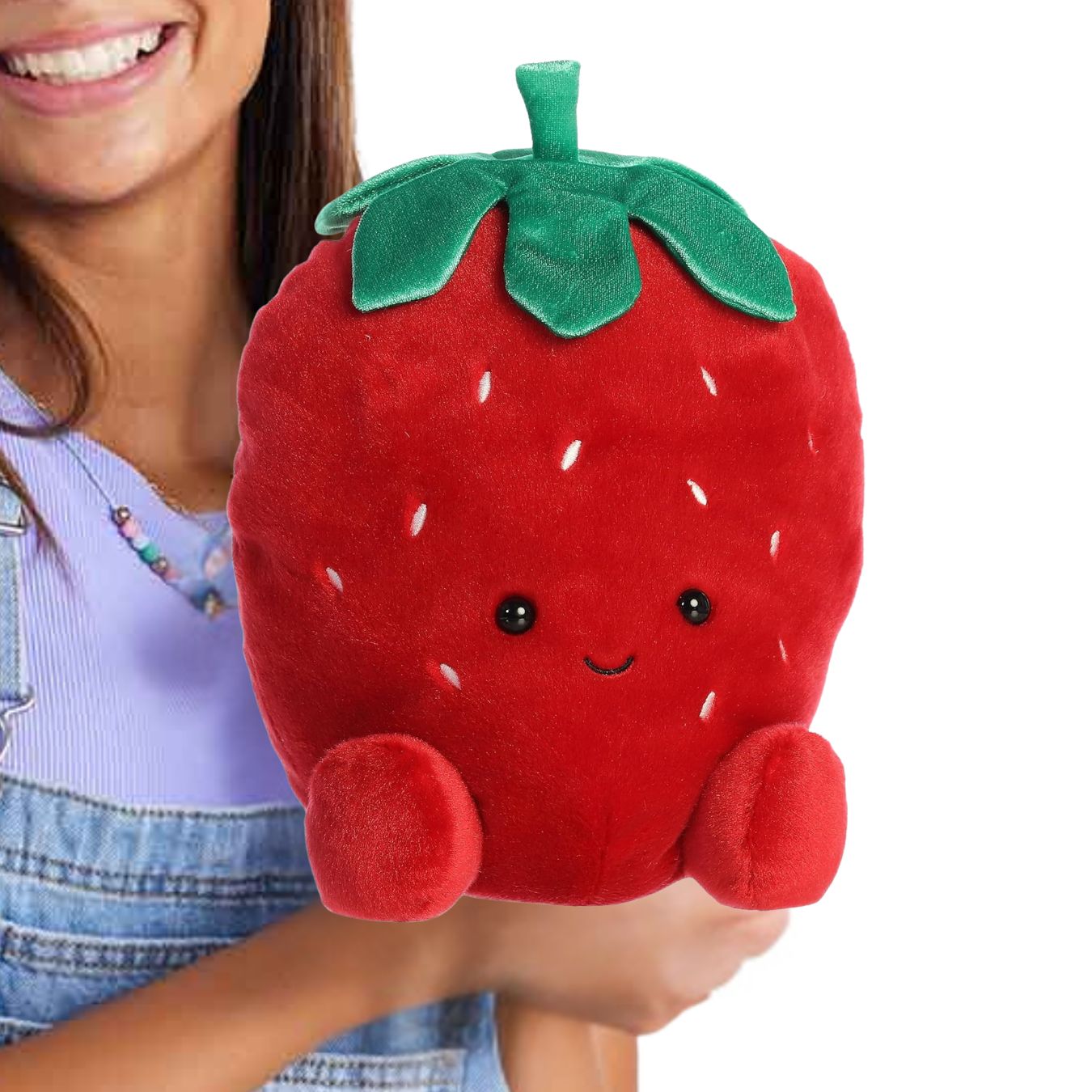 A person holding the extra-large 13-inch strawberry plush in their arms to showcase its large, huggable scale.