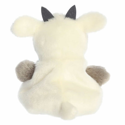 The rear view of the cream Aurora goat stuffed animal displaying its small floppy ears, back posture, and tiny tail.