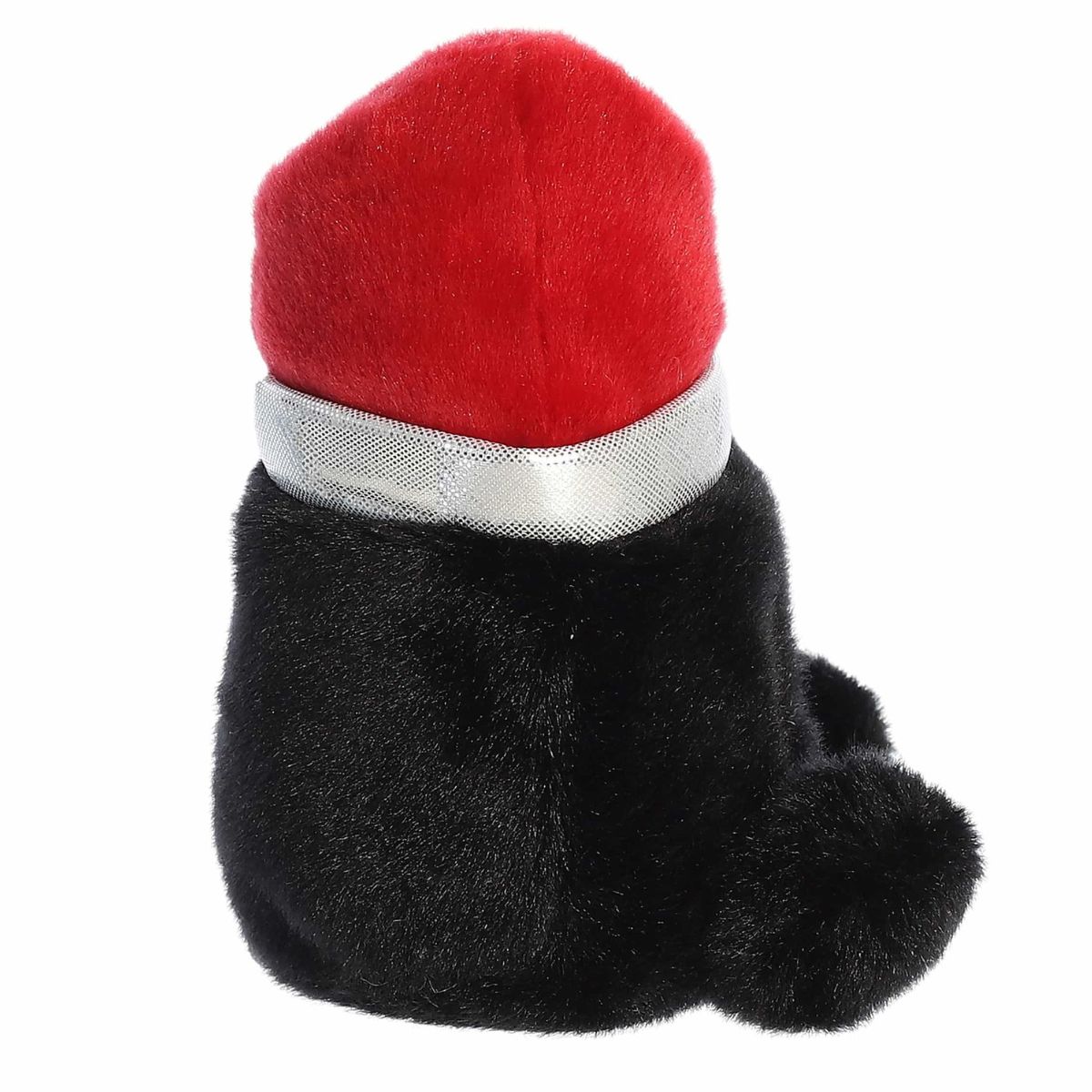 Right side profile view of the lipstick plush showing its rounded tube shape, sloped red top, and small black hand nub.