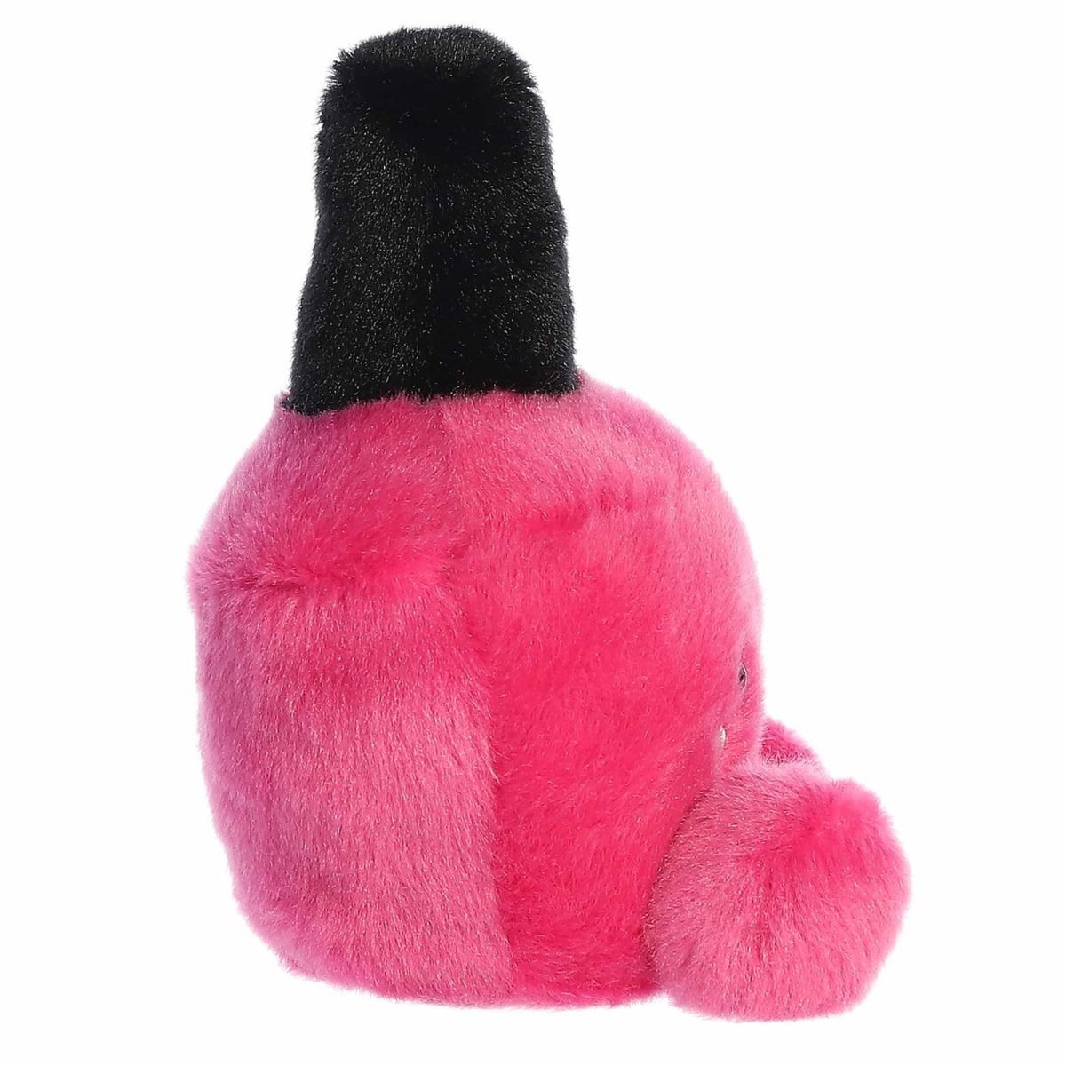 Right side profile view of the pink nail polish plush showing its rounded glass-bottle shape and black handle top.