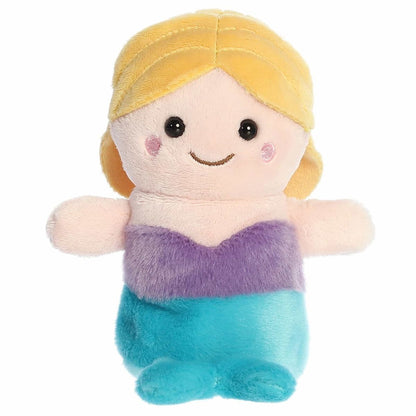 Straight-on front view of the mermaid stuffed animal highlighting its sweet stitched smile, dark eyes, and outspread peach-colored arms.