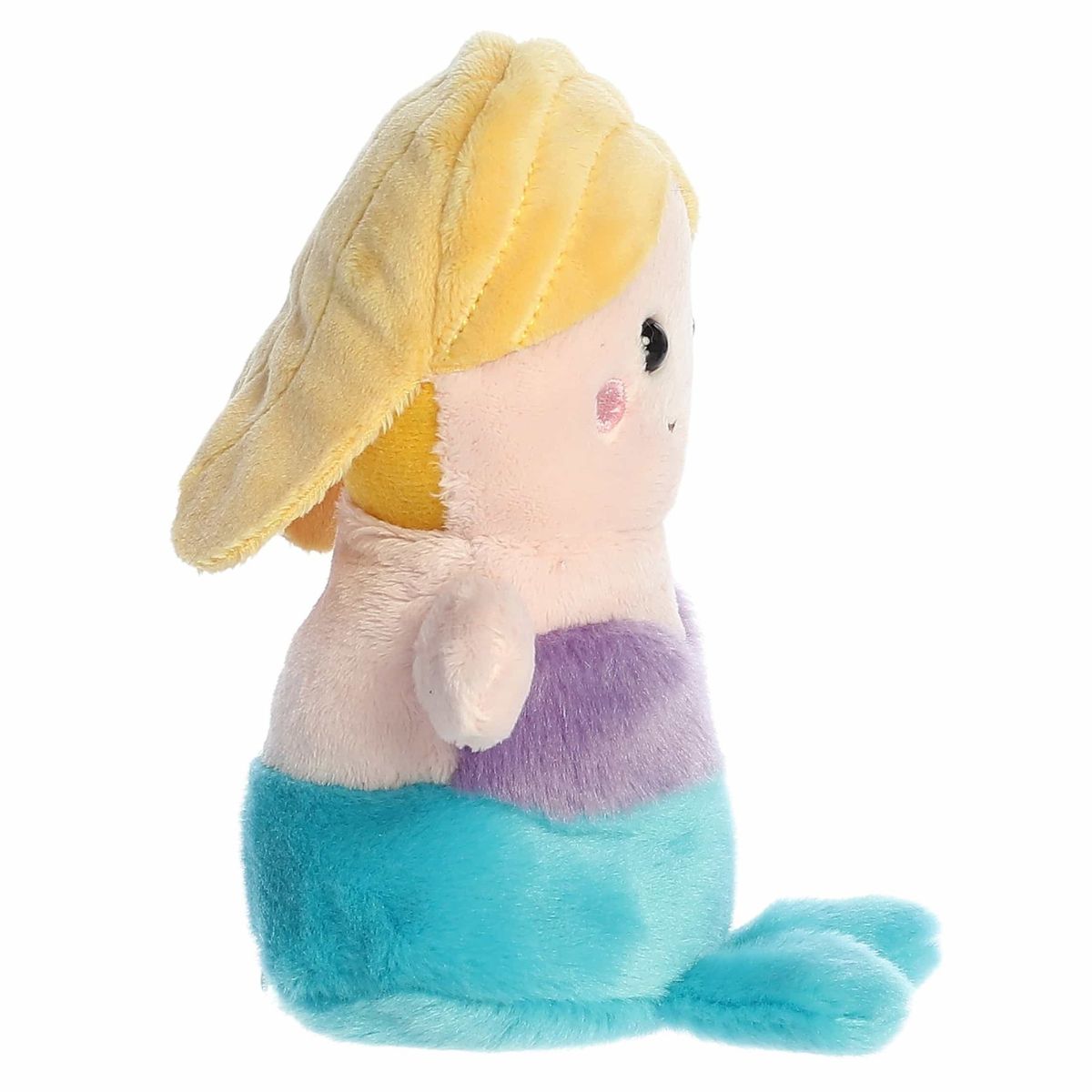 Right side profile view of the sitting mermaid plush showing its rounded head, yellow hair layered down its back, and flat teal tail fin.
