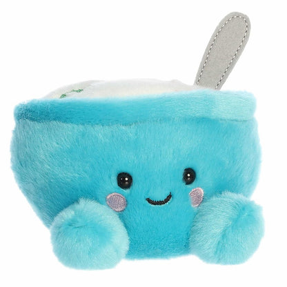 Three-quarter view of the Aurora Palm Pals Trixie Breakfast Cereal 5-inch plush sitting upright, featuring a turquoise-blue bowl and a grey spoon.