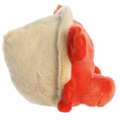 The right side view of the sitting Aurora Palm Pals hermit crab plush highlighting its soft beige shell encasing its back.