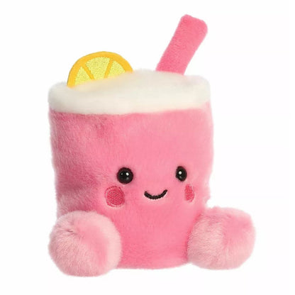 Aurora Palm Pals Zelie 5-inch Pink Lemonade plush stuffed toy sitting at a slight angle with a bubblegum pink cup body, white plush foam top, and a yellow lemon wedge.