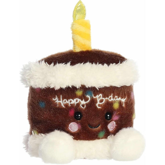 Aurora Palm Pals Choco B'Day 5-inch Birthday Cake plush stuffed toy sitting forward with chocolate brown fur, white frosting trim, and a yellow candle.