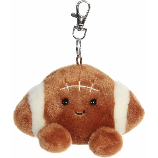 Straight-on front view of the 4-inch Aurora Palm Pals Tackle Football brown clip-on plush featuring a smiling face.