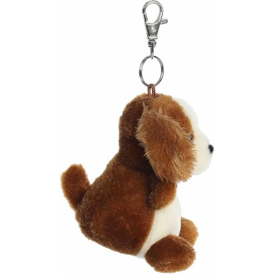 Side profile view of the Lady Spaniel plush keychain showing its little tail, upright posture, and metal clip.