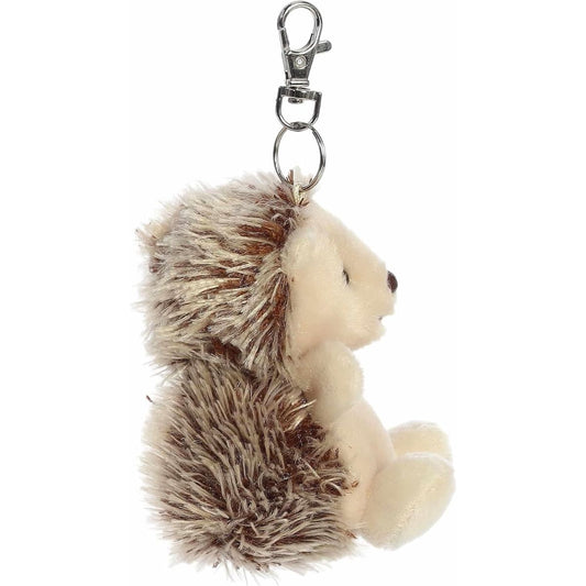 Side profile of the soft Palm Pals hedgehog clip-on stuffed animal showing its fluffy brown back.
