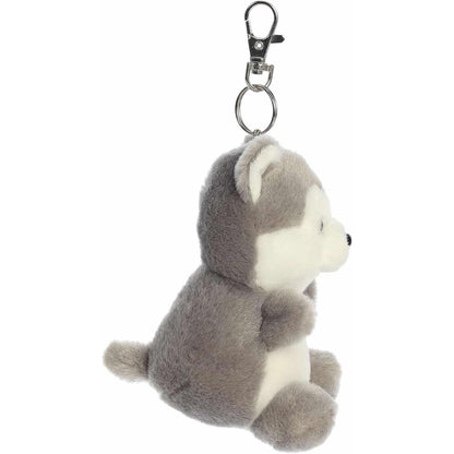 Side profile view of the Busky Husky plush keychain showing its little tail, upright posture, and metal clip.