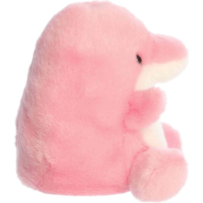 Side profile view of the Palm Pals Pink Dolphin plush highlighting its perfectly squishy round body, pink dorsal fin, and prominent snout.