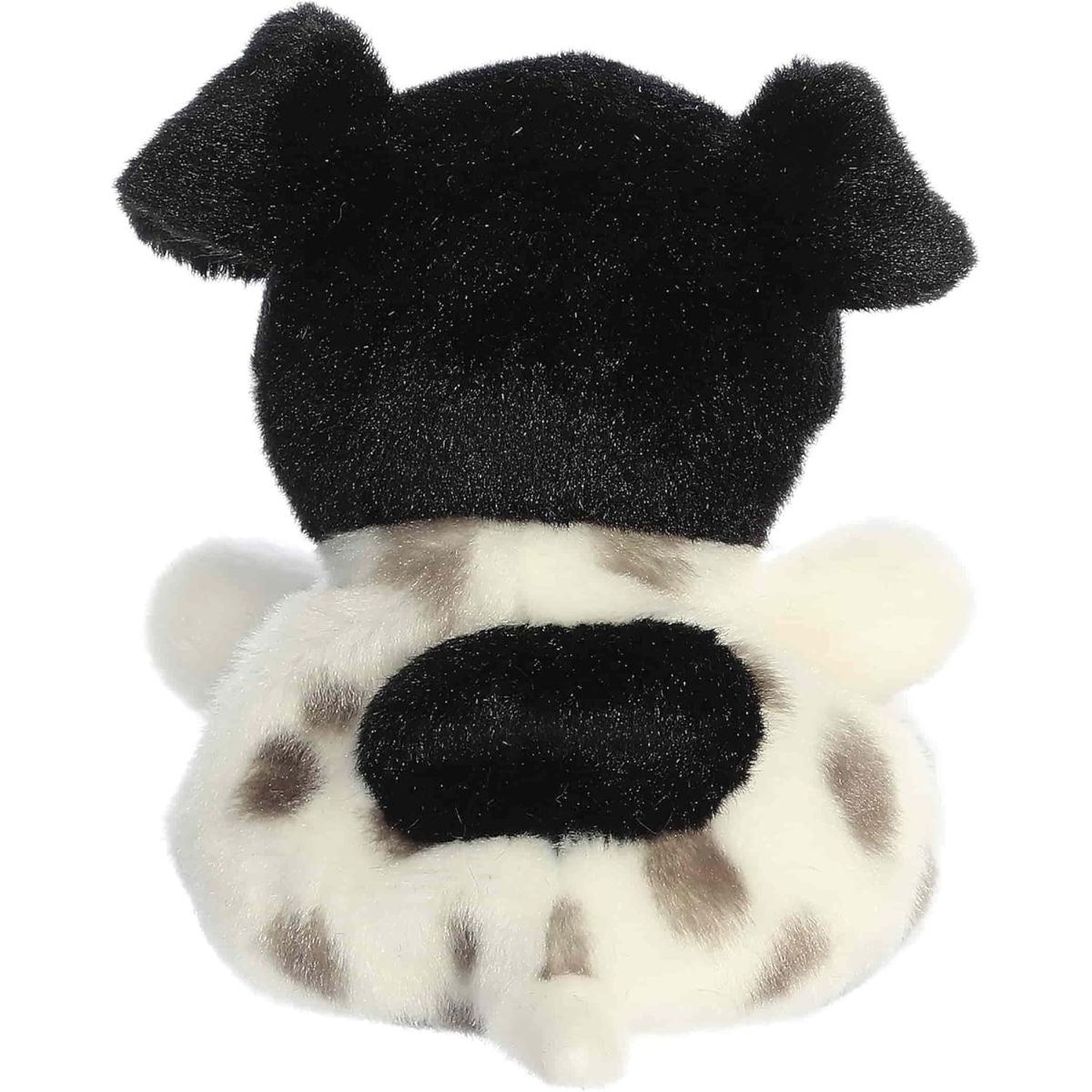 Back view of the Aurora puppy plush showcasing its white fur with grey spots, black ears, and a large black patch on its lower back.