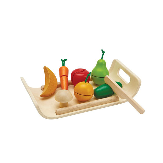 The PlanToys wooden assorted fruit and vegetable set displayed on a handled tray with a play knife.
