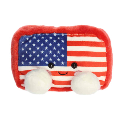 Straight-on front view of the soft American flag Palm Pals stuffed animal with a smiling face.