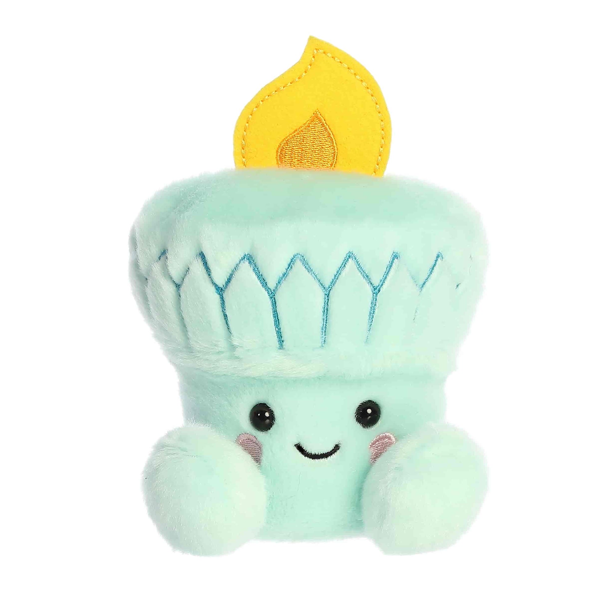 Straight-on front view of the soft mint blue Palm Pals torch stuffed animal featuring a smiling face and pink cheeks.