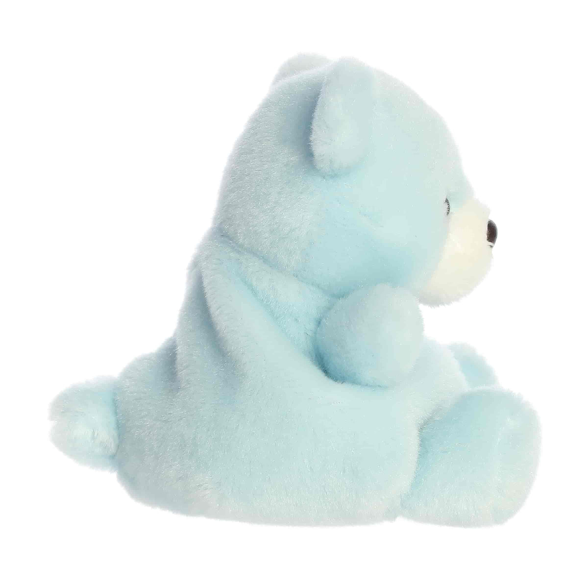 Side profile view of the Palm Pals Benny Bear highlighting its plump shape and tiny plush tail.