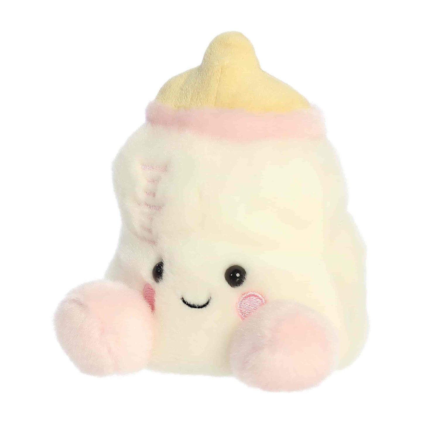 Slightly angled view of the cheerful Palm Pals Thea Baby Bottle plush sitting upright.