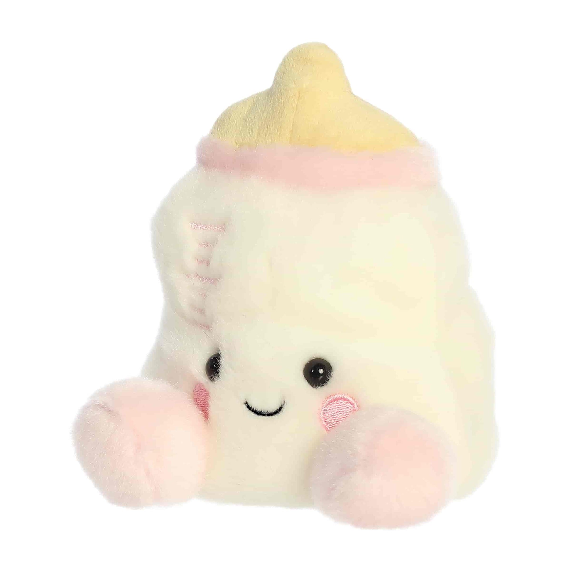 Slightly angled view of the cheerful Palm Pals Thea Baby Bottle plush sitting upright.