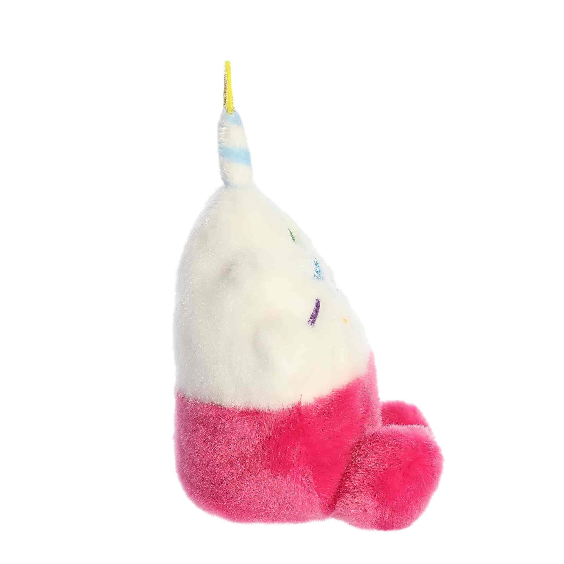 Side profile of the Aurora Palm Pals Sparkle Birthday Cupcake plush highlighting its pink base and white frosting.