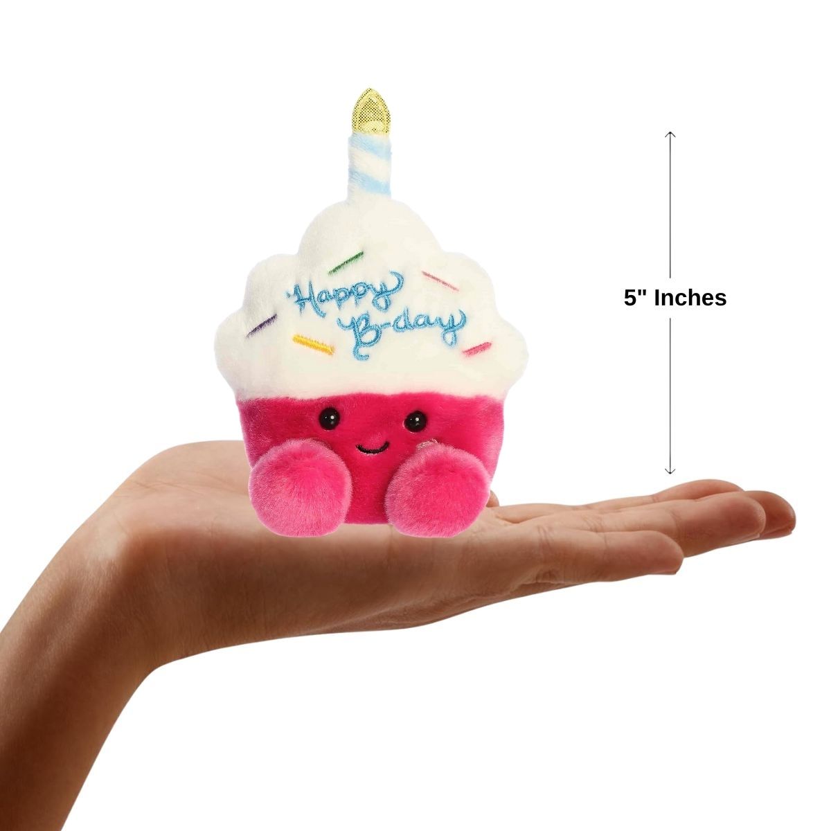 Dimension graphic showing the 5-inch Aurora Palm Pals Sparkle Birthday Cupcake resting comfortably in a person's hand.
