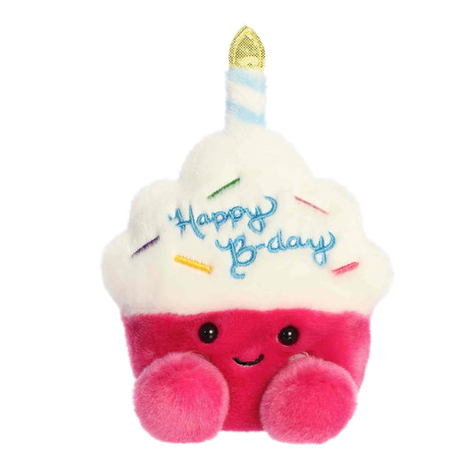 Straight-on front view of the soft Palm Pals cupcake stuffed animal featuring Happy Birthday embroidery and a smiling face.