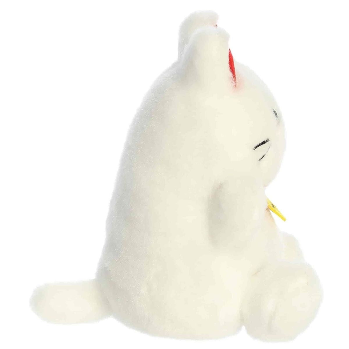 Side profile view of the Palm Pals Kota Lucky Cat highlighting its plump shape and tiny plush tail.