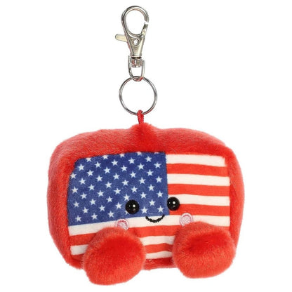 Front face view of the adorable Aurora Indivisible Flag stuffed toy showing its stars and stripes pattern, sweet smile, and rosy cheeks.