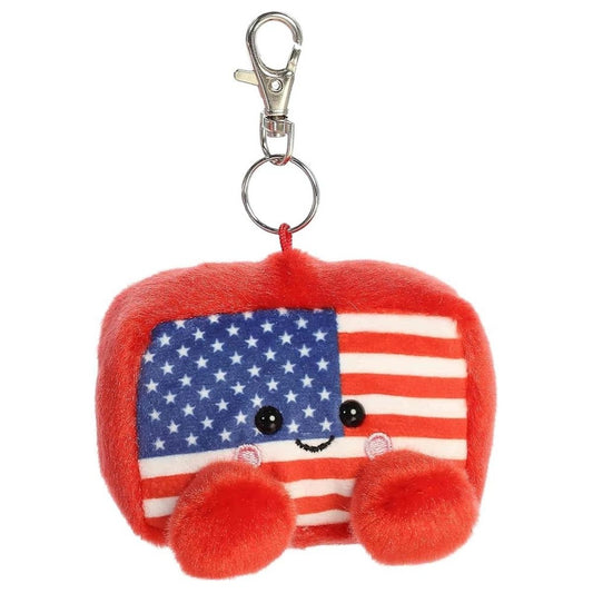 Front face view of the adorable Aurora Indivisible Flag stuffed toy showing its stars and stripes pattern, sweet smile, and rosy cheeks.