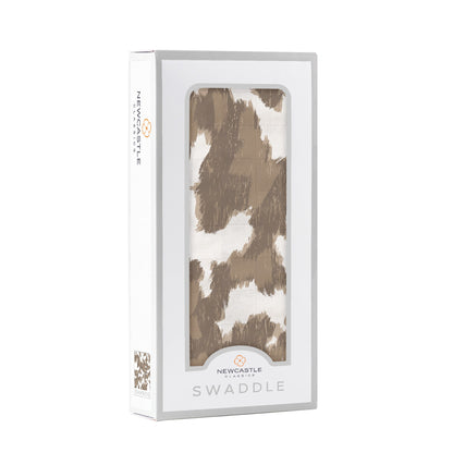 Angled front view of the Newcastle Classics swaddle blanket folded inside a white window display box.