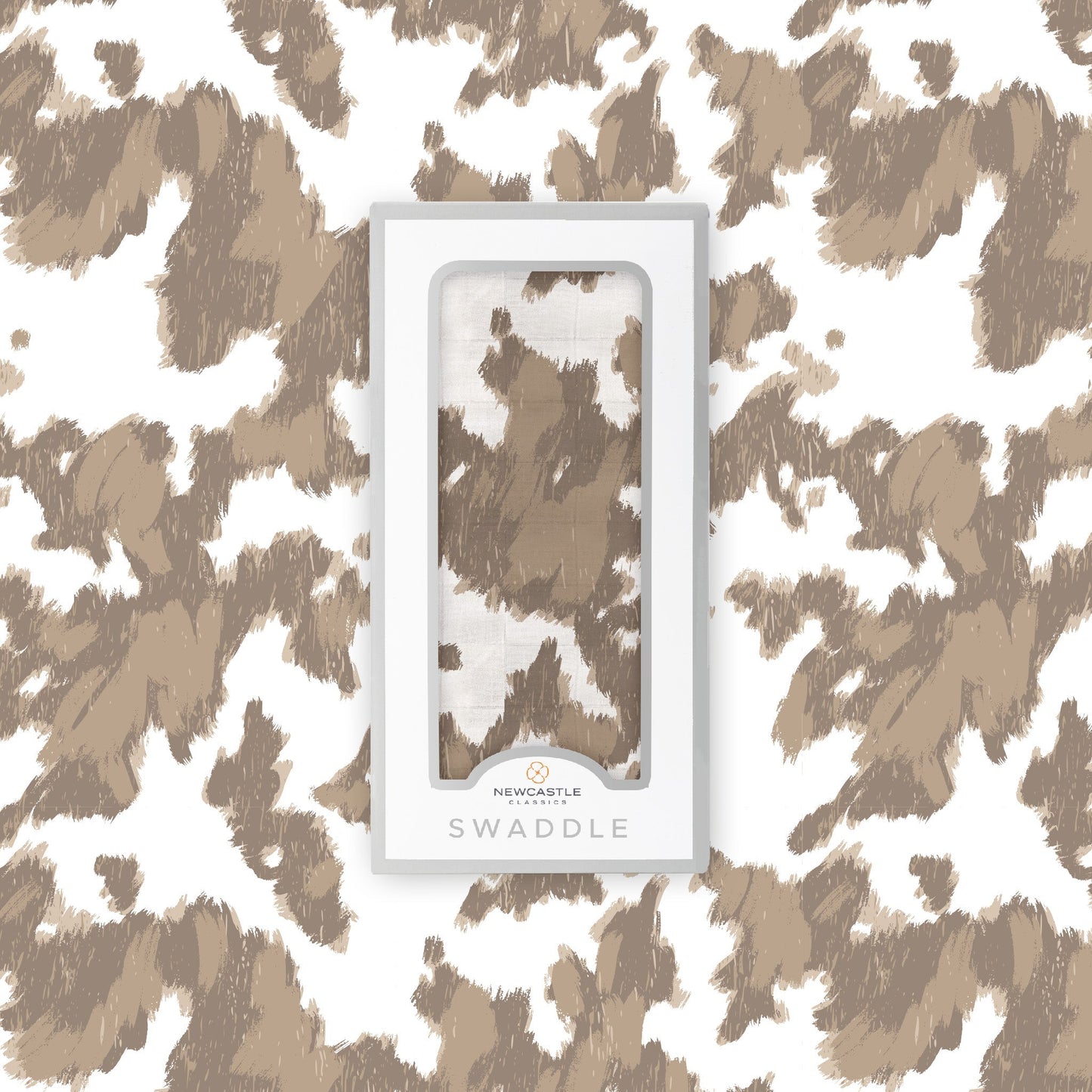Flat lay of the Newcastle Classics Yellowstone Cowhide bamboo muslin swaddle blanket shown with its branded white packaging box in the center.