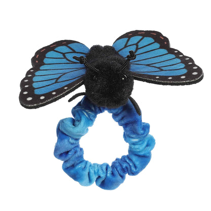 Front view of the butterfly's sweet face and black antennae sitting atop the stretchy blue plush wristband.