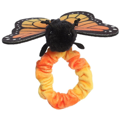Front view of the butterfly's cute face and black antennae sitting atop the stretchy plush wristband.