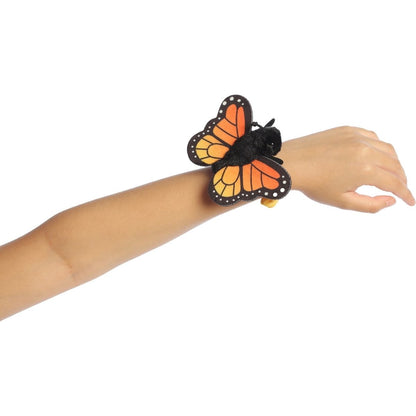 Butterfly-shaped wristband on a mannequin arm against a white background