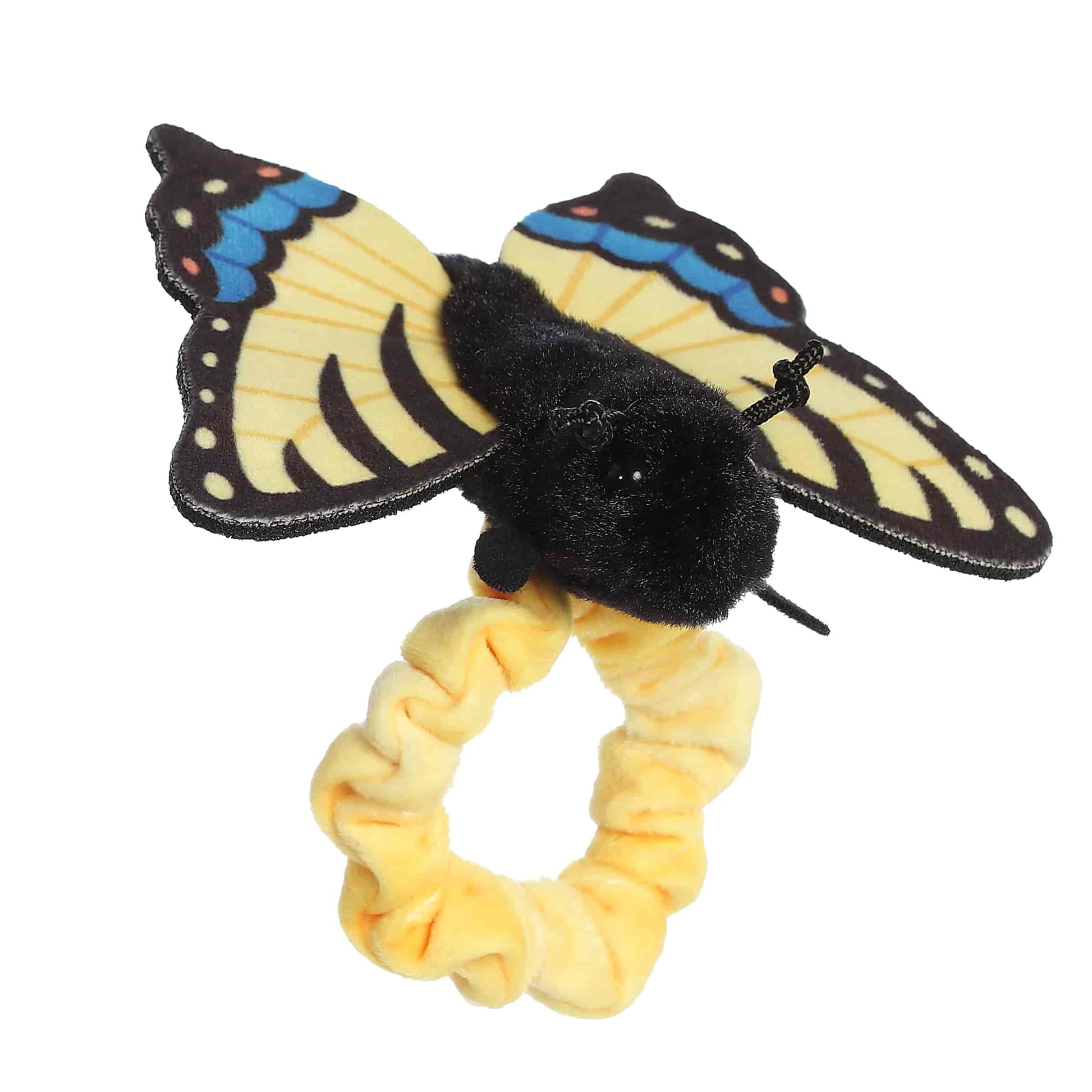 Angled side view of the wearable butterfly plush showing its fluffy black body and outstretched swallowtail fabric wings.