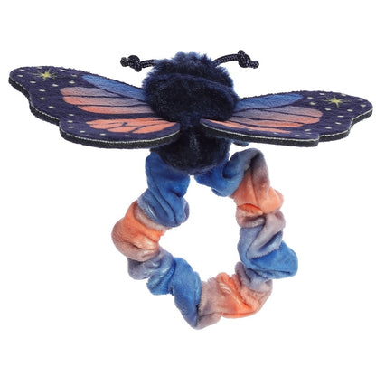 Front view of the butterfly's sweet face sitting atop the stretchy blue and orange plush wristband.