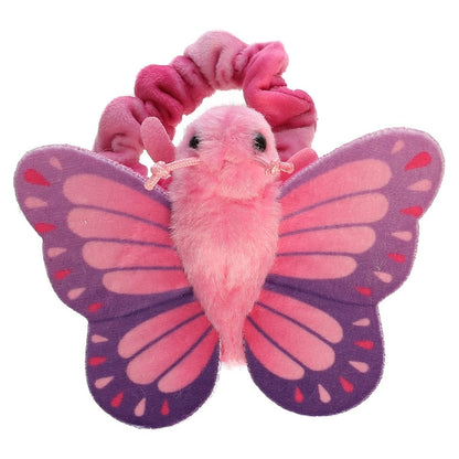 Top-down view of the pink and purple plush butterfly resting flat against its pink scrunchie-style wristband.