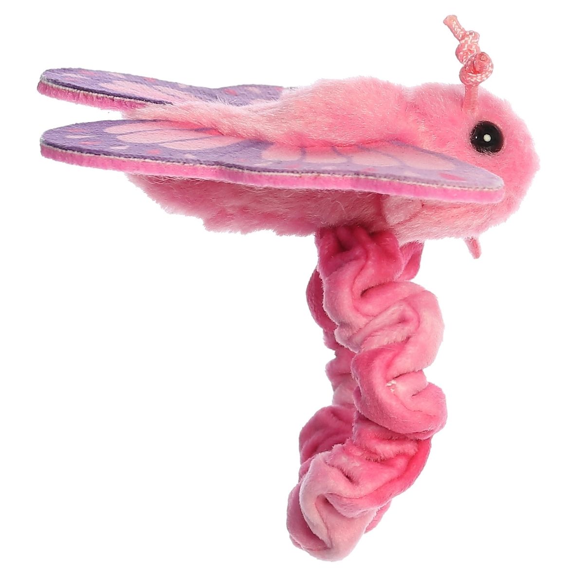 Side profile view of the wearable butterfly plush showing its fluffy pink body and outstretched fabric wings.