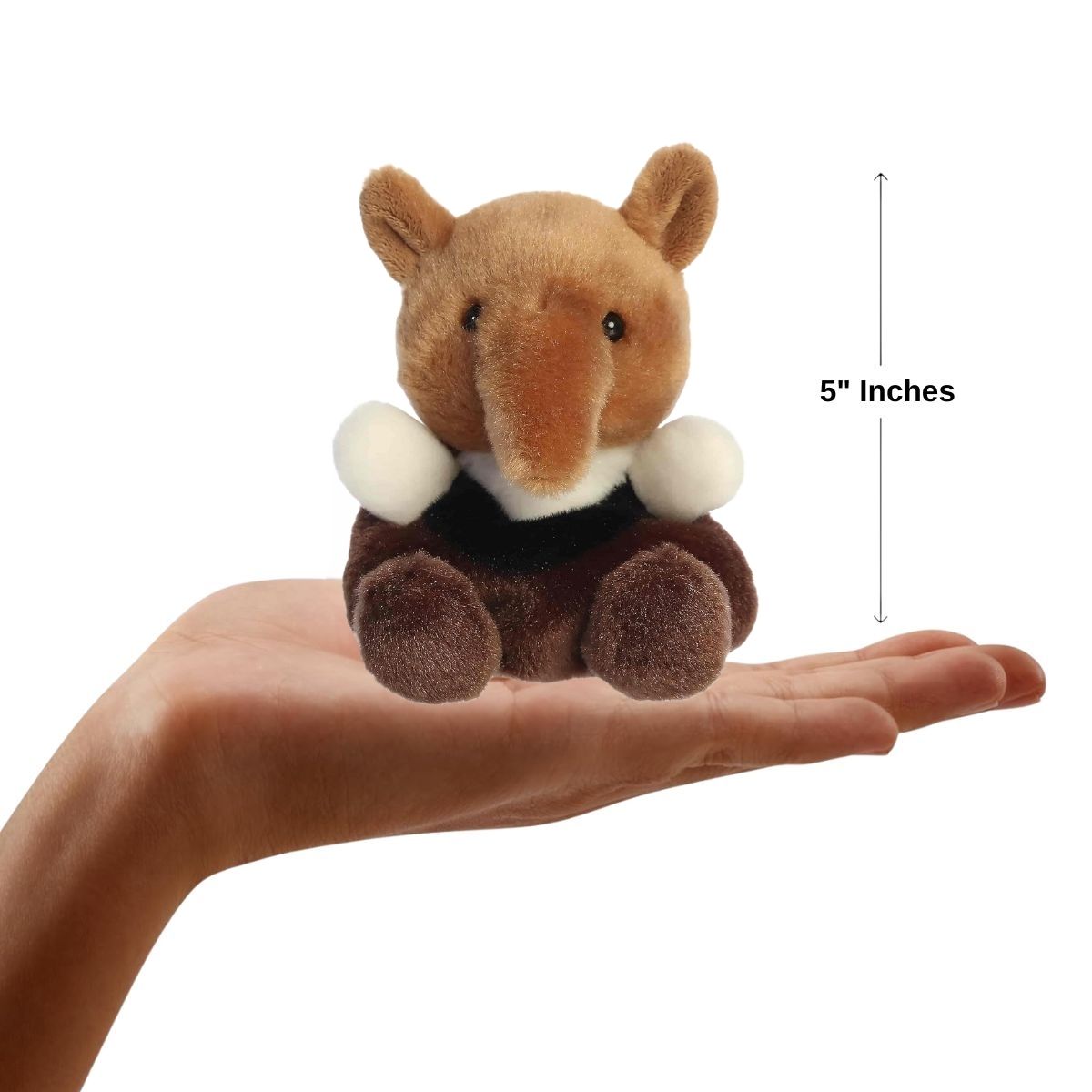 A hand holding the Aurora Palm Pals Anita Anteater plush, demonstrating its small, 5-inch palm-sized design.