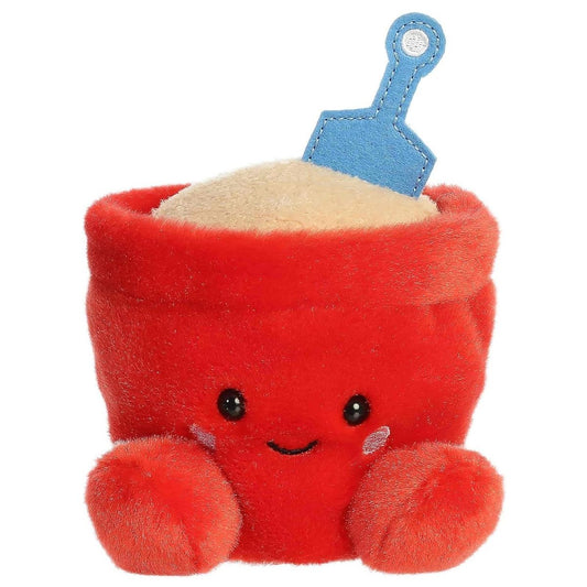 Straight front view of the June Sand Bucket plush toy highlighting her cute embroidered smile, dark eyes, and pink cheeks.