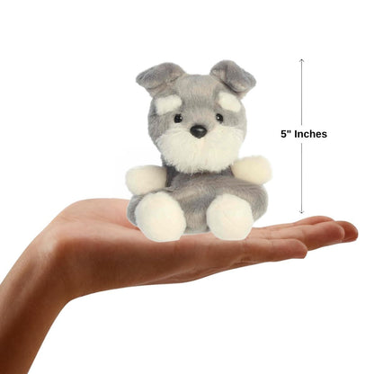 A human hand holding the five-inch Korra Schnauzer, illustrating the small-scale proportions of the toy.
