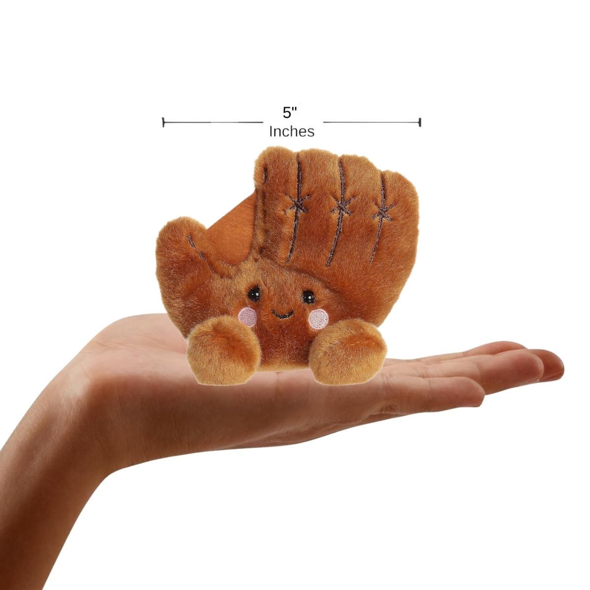 A person's open hand holding the five-inch Tag Baseball Glove, demonstrating its miniature scale.